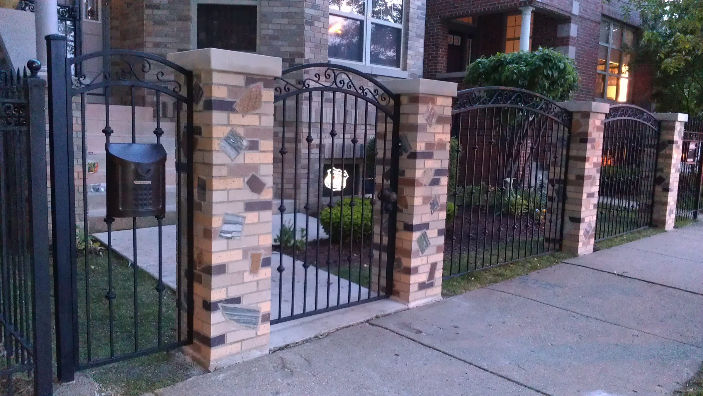 A custom arched steel gate and fence in front of a Chicago home